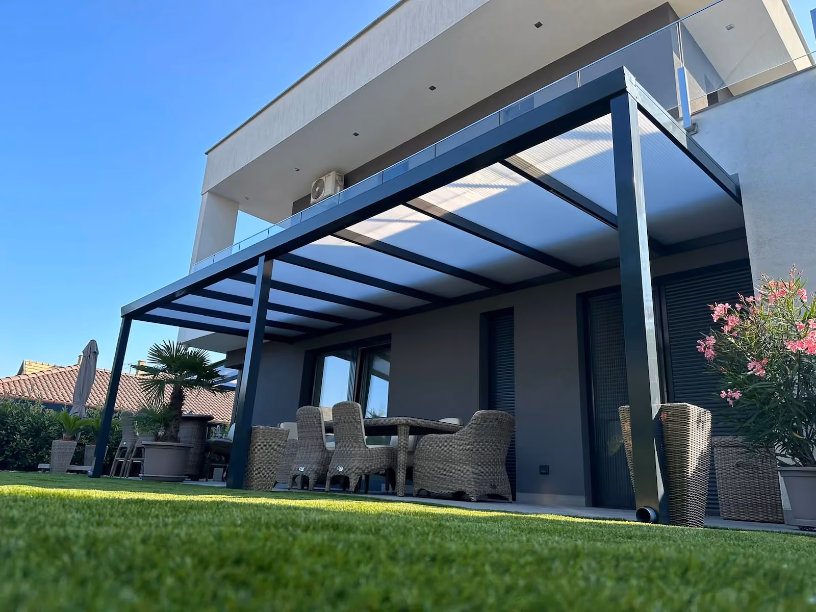 Custom aluminium pergola installed beside a modern terrace