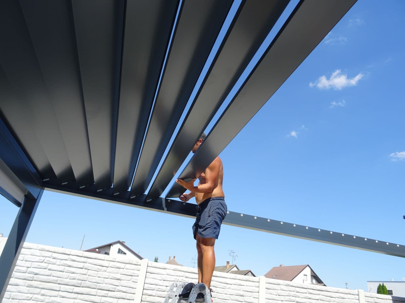 Inserting the aluminium louvres of a bioclimatic pergola
