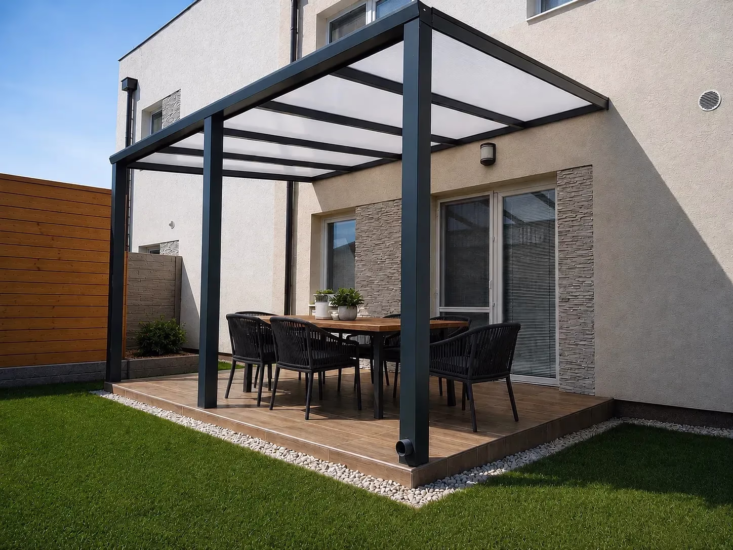 Anthracite Basic Class aluminium pergola over a terrace with a dining table