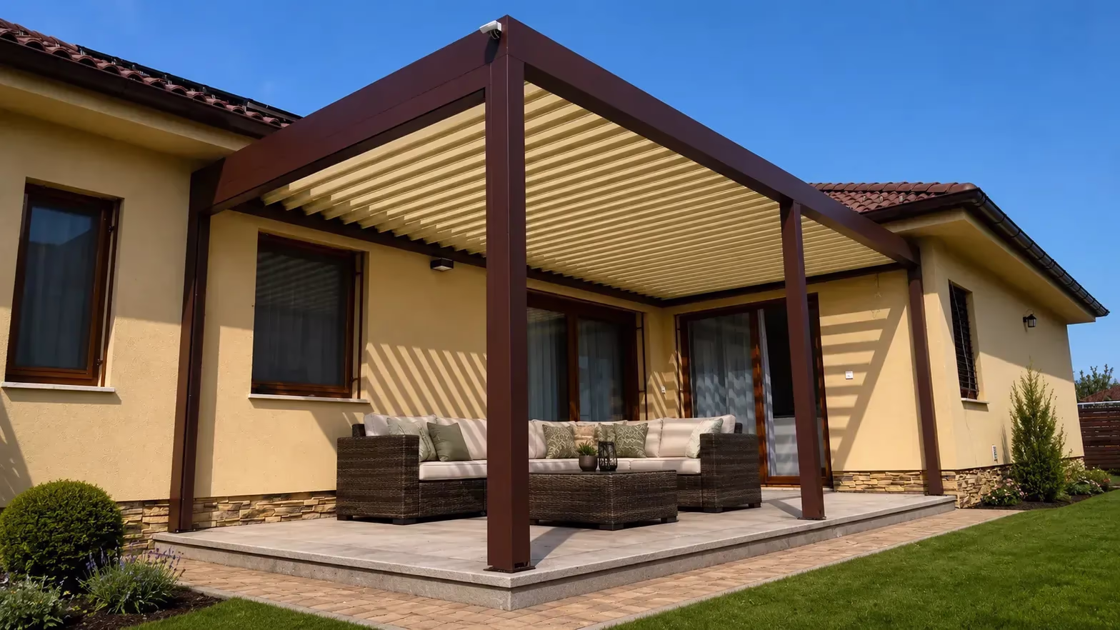 Brown bioclimatic pergola made of durable aluminium with closed louvres over a terrace