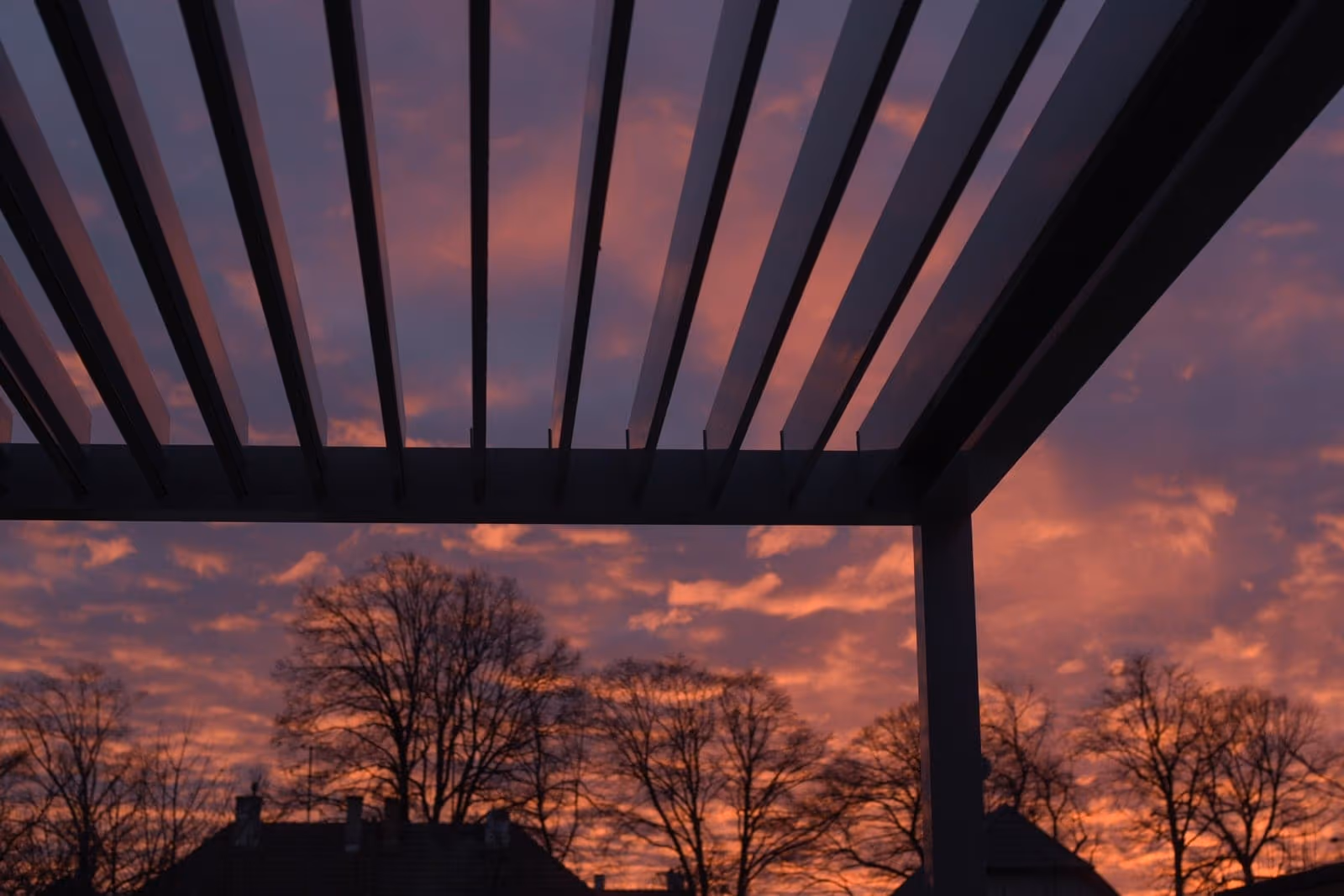 Bioclimatic pergola with tilting louvres at sunset