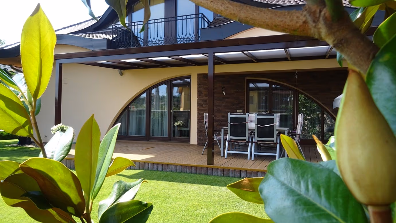 Economic Class aluminium pergola at a front door with hanging flower pots