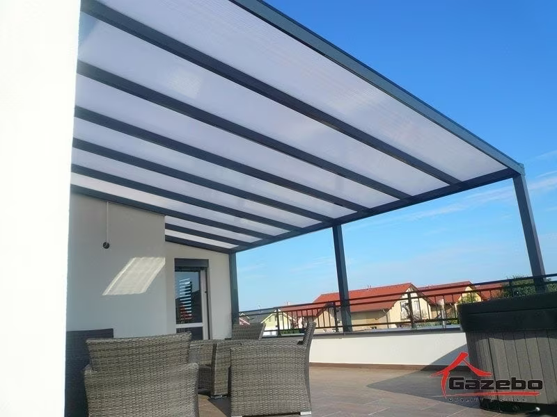 Anthracite Economic Class aluminium pergola on a roof terrace with rattan seating