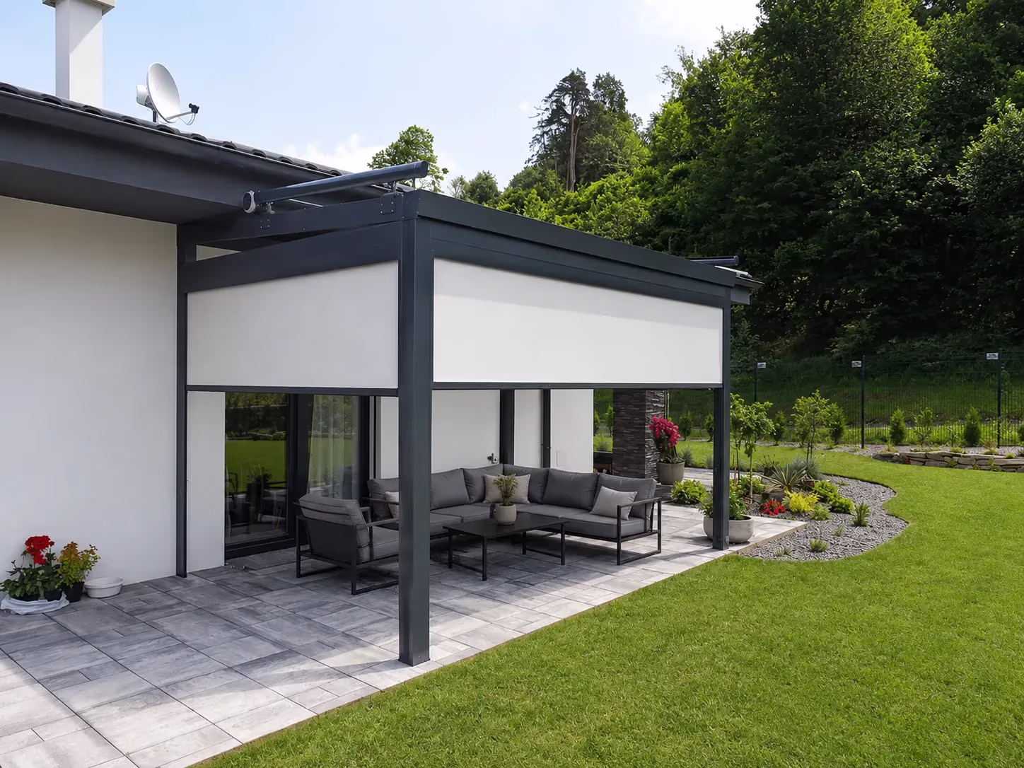 Anthracite Top Class pergola with electric roller screens over a terrace beside a brick house