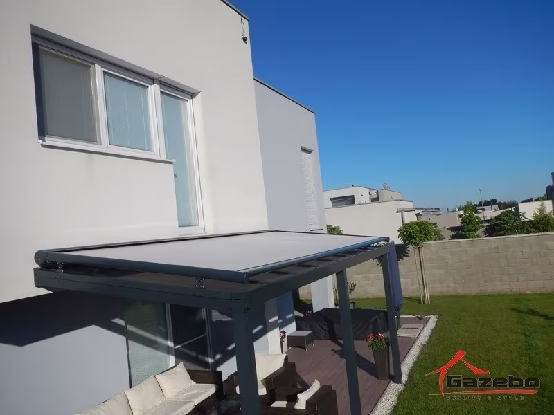 Anthracite Top Class aluminium pergola with front shading on a terrace by a modern white house