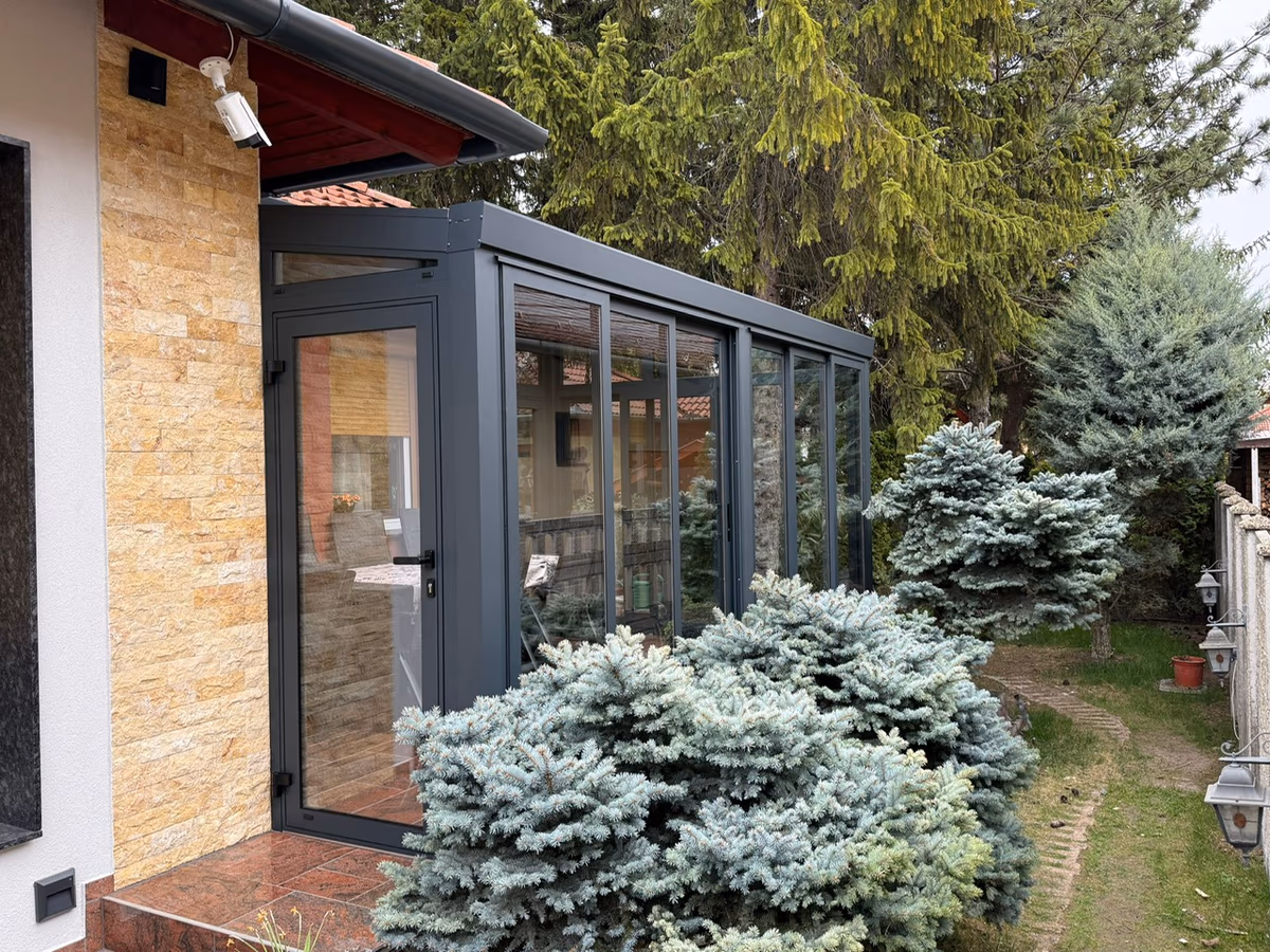 Glazed aluminium winter garden extending a Top Class pergola beside a house