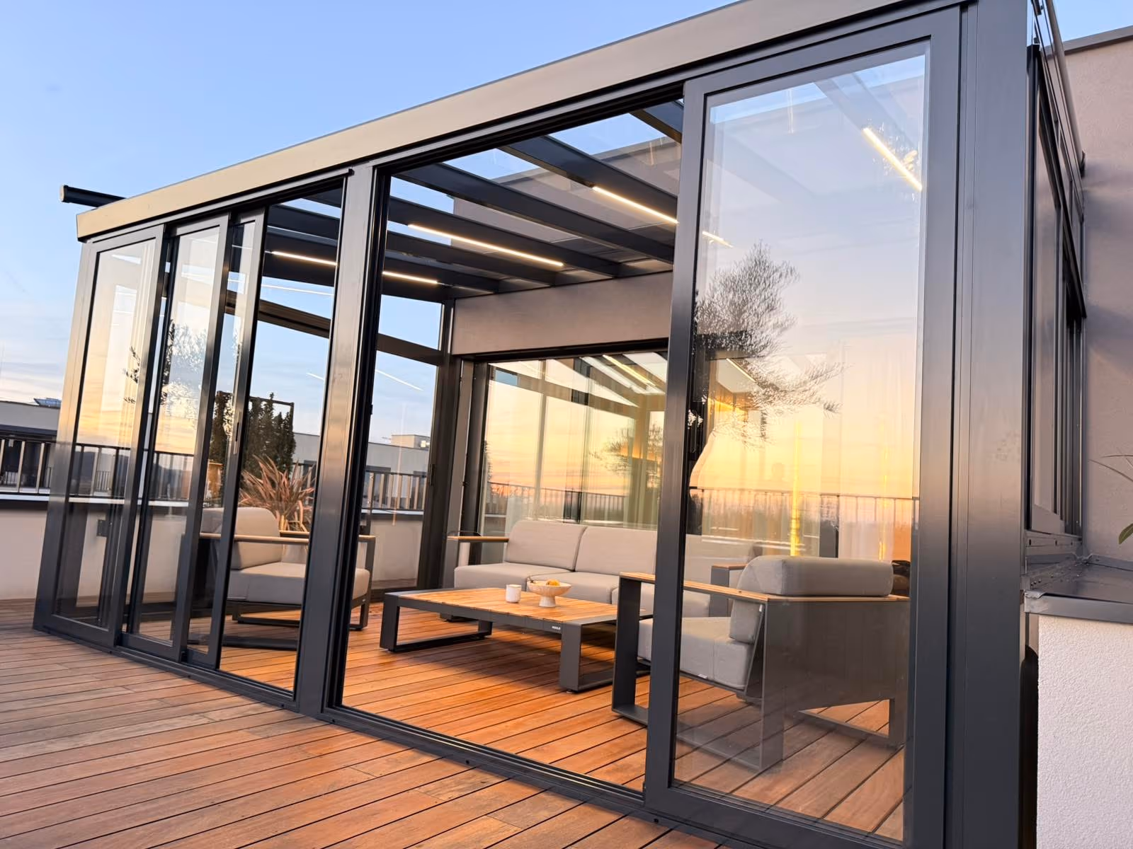 Top Garden 2 winter garden with open sliding glass walls on a rooftop terrace
