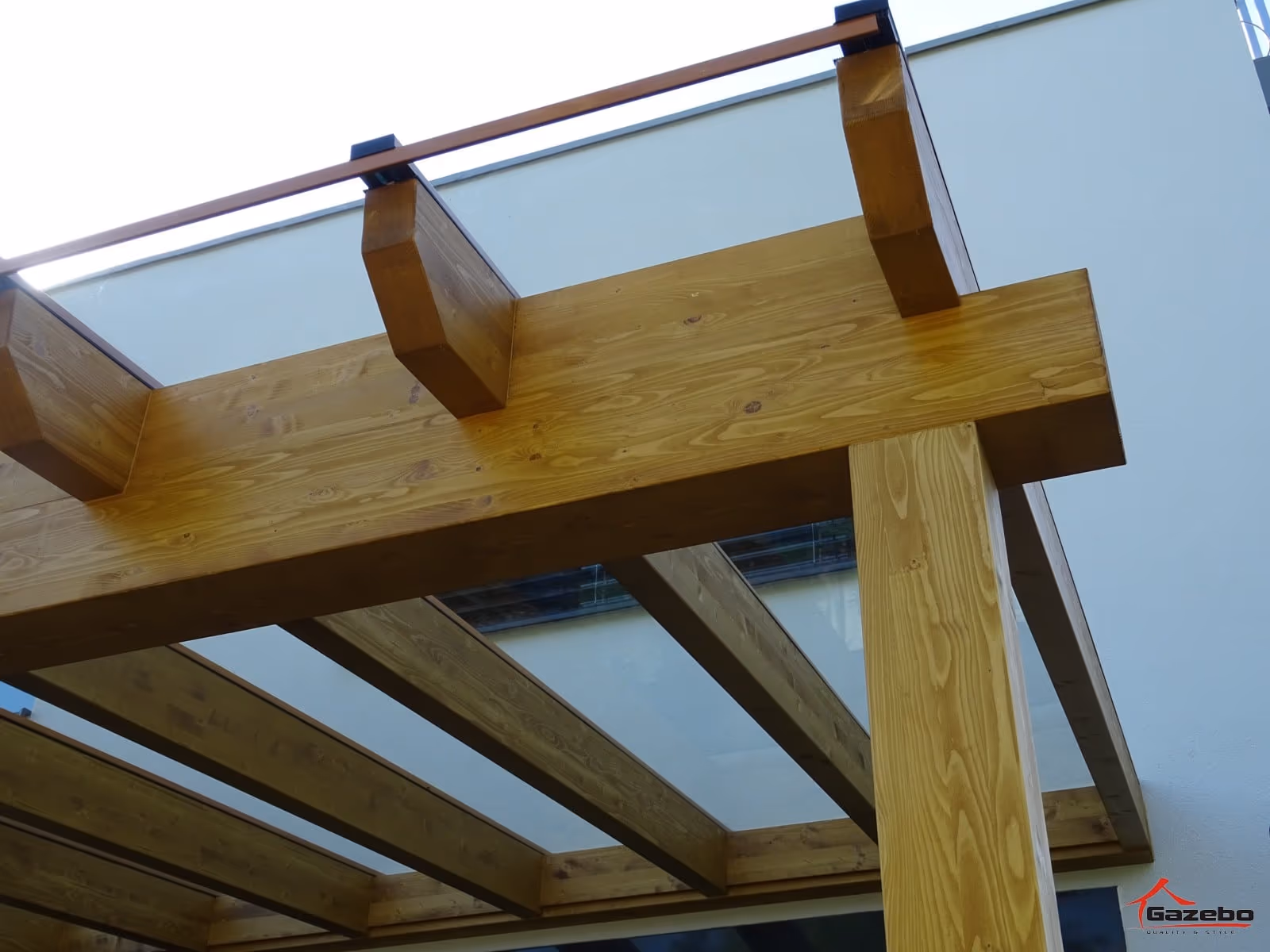 Kartago wooden pergola with a pitched roof over a terrace