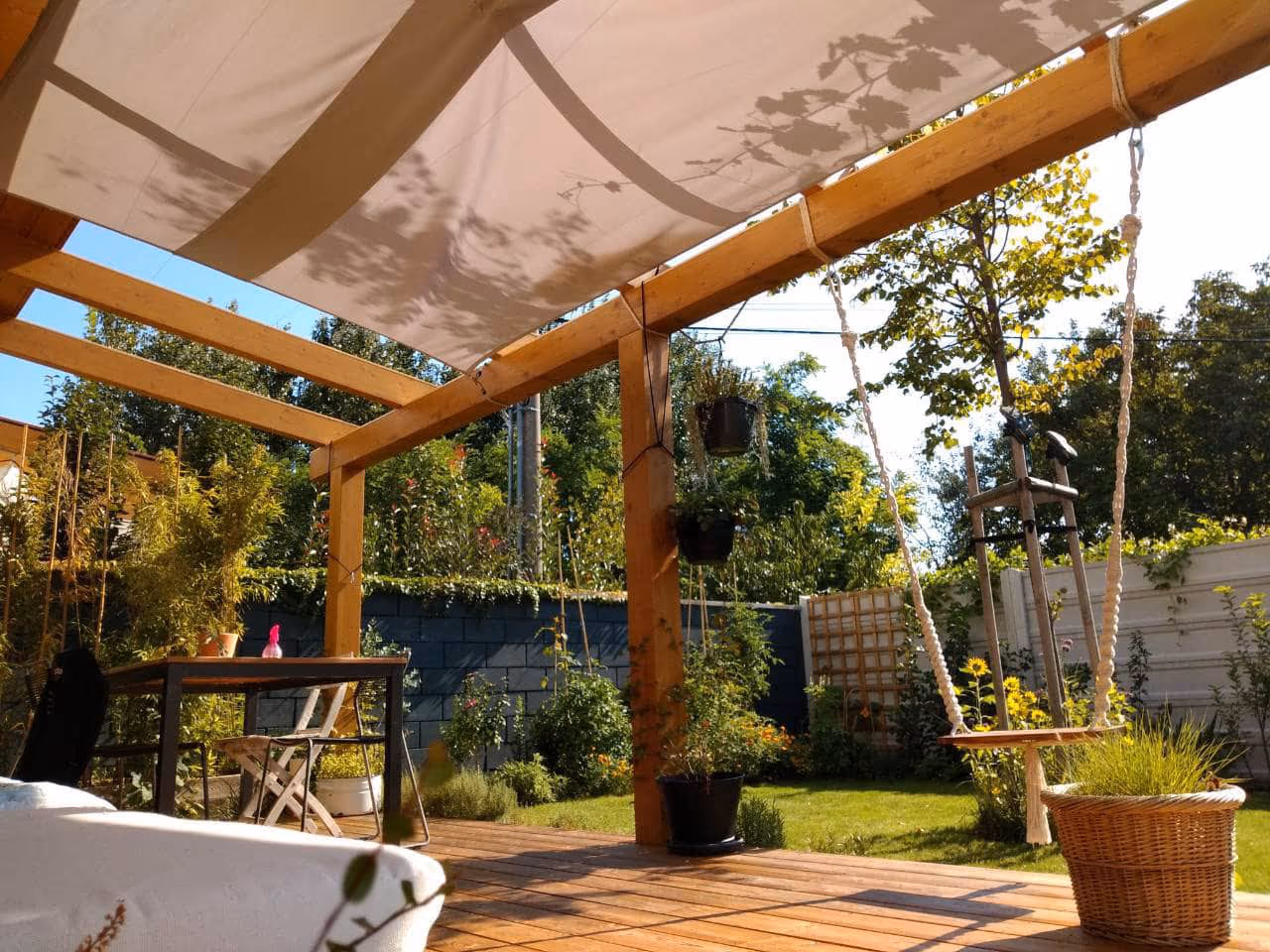 Kartago wooden pergola in laminated timber in a garden