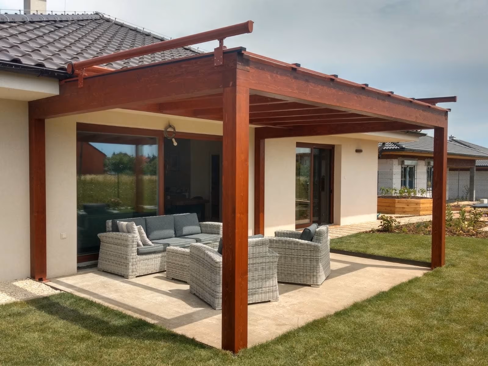 Milano wooden pergola with rattan seating in the garden