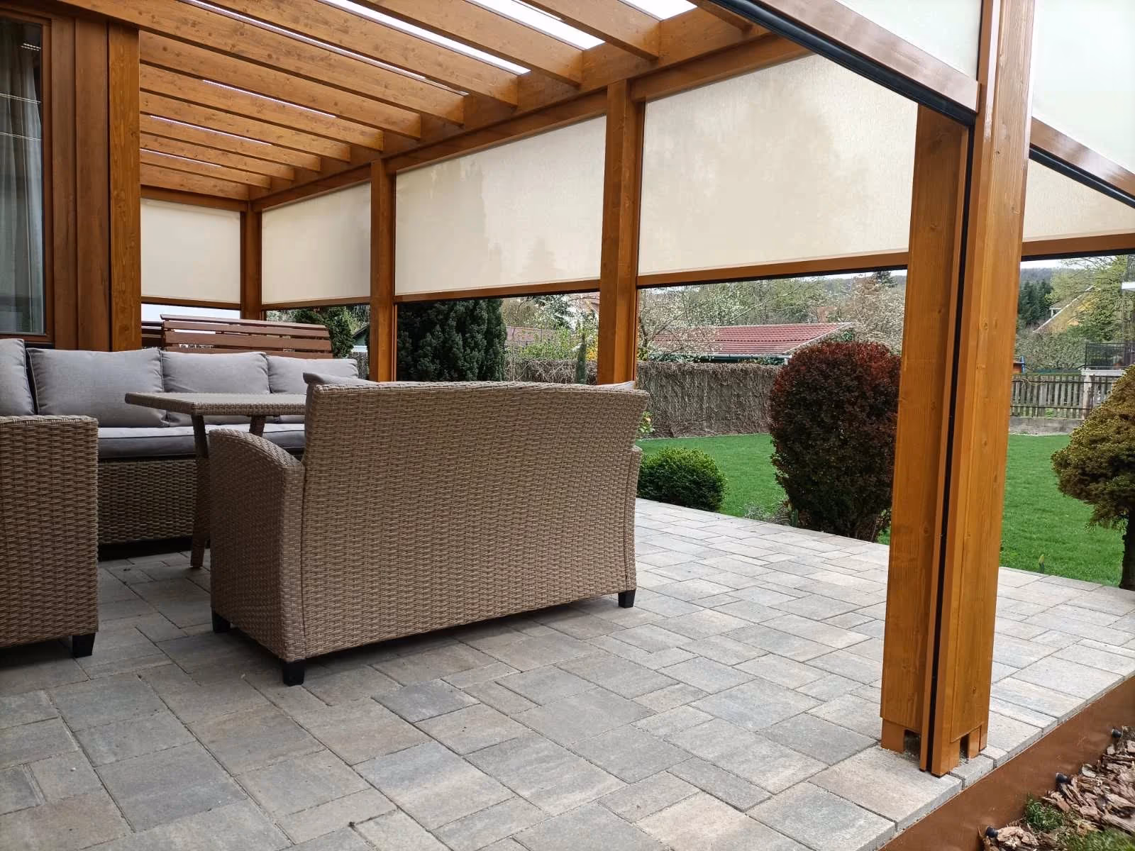 Milano wooden pergola with comfortable seating on paving