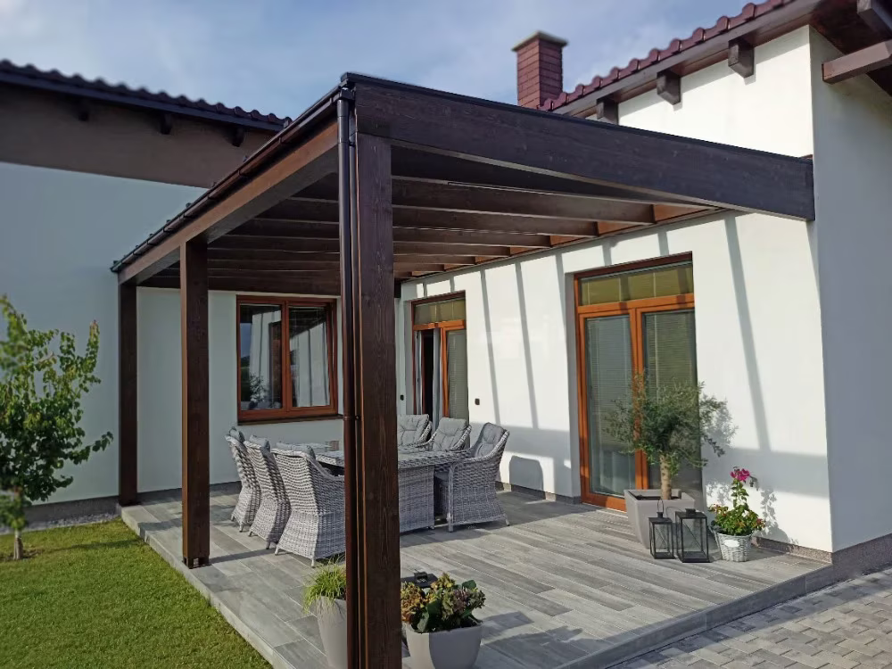 Milano wooden pergola over a terrace with seating by a family home