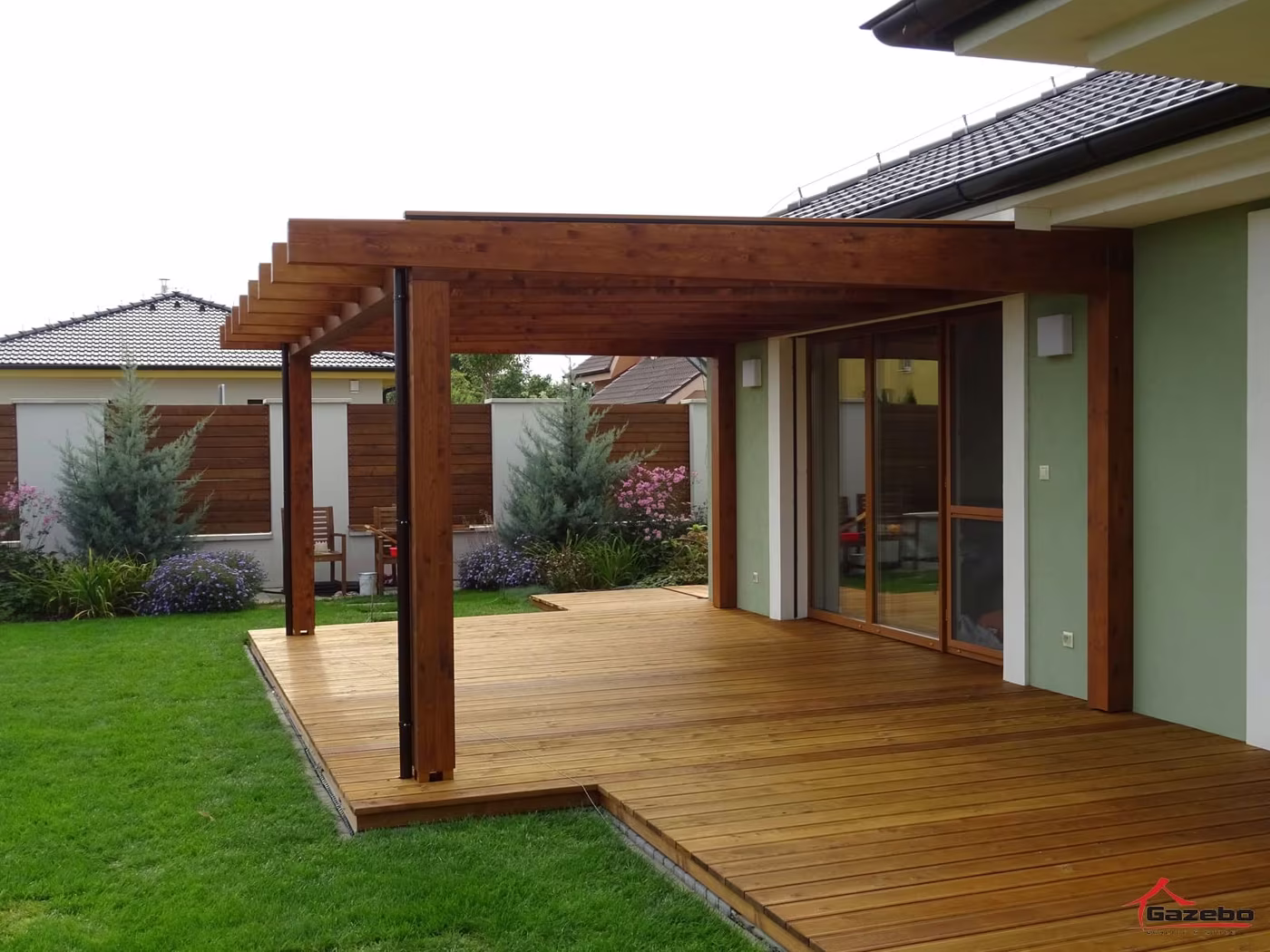 Fenix wooden pergola over a raised wood deck by a family home